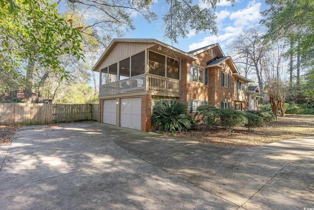 view of front of home featuring a sunroom and a garage