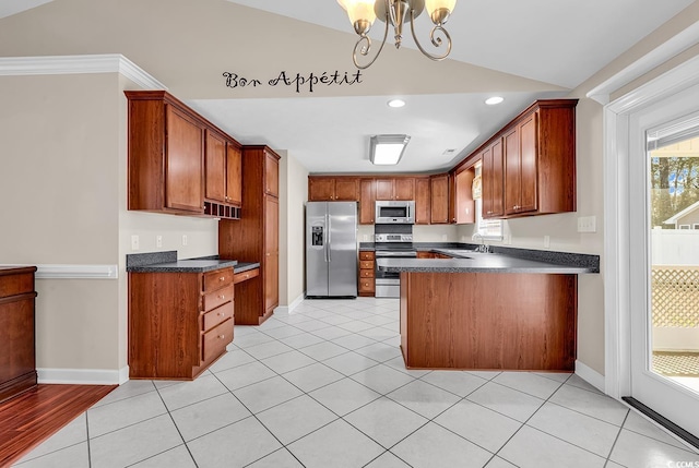 kitchen featuring dark countertops, a peninsula, vaulted ceiling, stainless steel appliances, and a sink