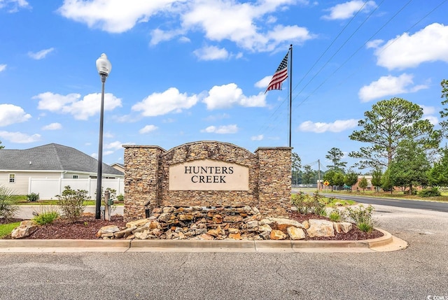 community sign featuring fence