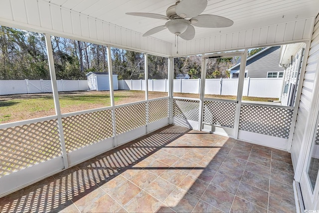 unfurnished sunroom with a ceiling fan