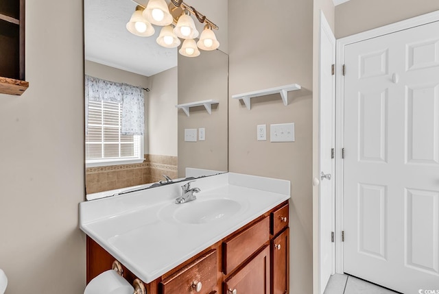 bathroom featuring an inviting chandelier, tile patterned floors, and vanity