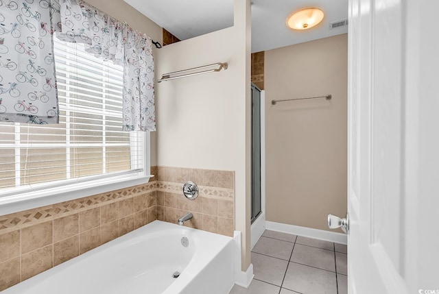 full bathroom featuring visible vents, plenty of natural light, a garden tub, and tile patterned floors