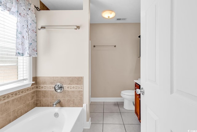 bathroom featuring toilet, visible vents, baseboards, a bath, and tile patterned floors