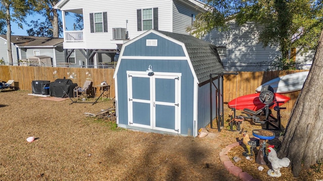 view of outbuilding featuring central AC unit and a lawn