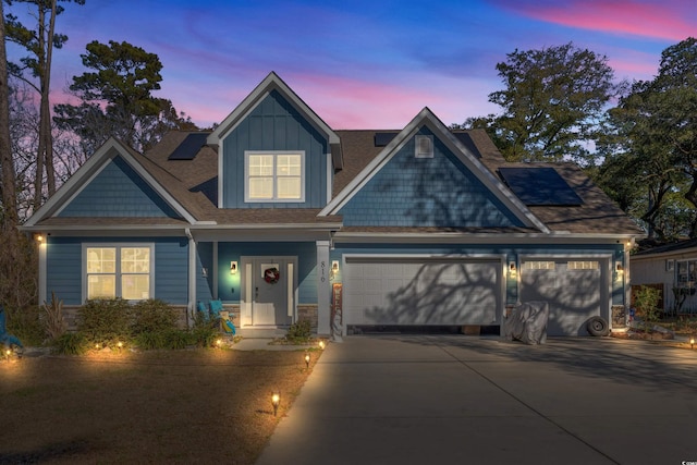 view of front of house with solar panels and a garage