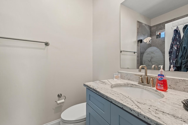 bathroom featuring toilet and vanity