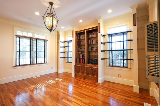 interior space featuring ornamental molding and hardwood / wood-style floors