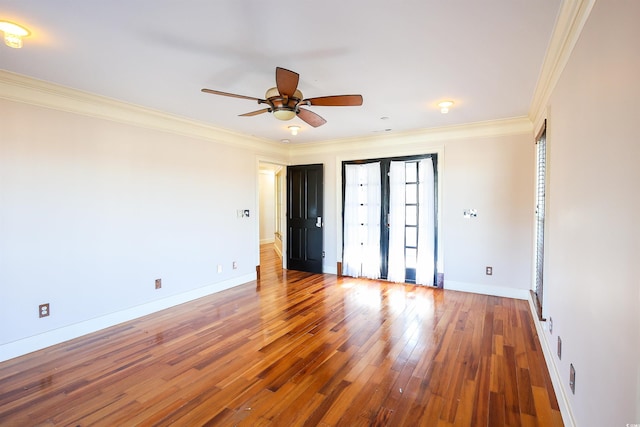 unfurnished room with ceiling fan, ornamental molding, and wood-type flooring