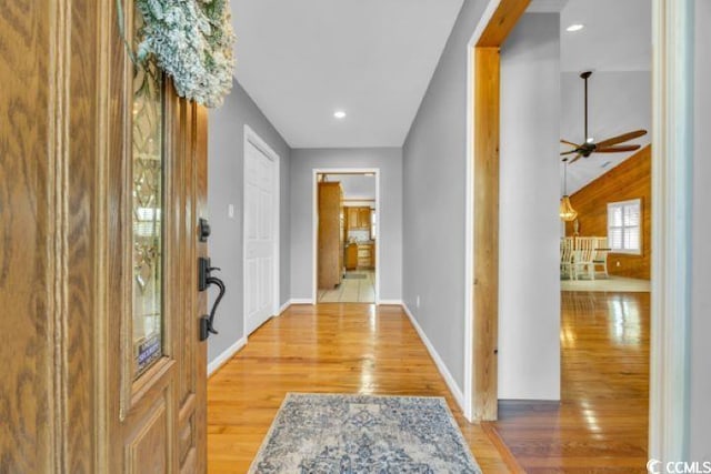 foyer with wood-type flooring and ceiling fan