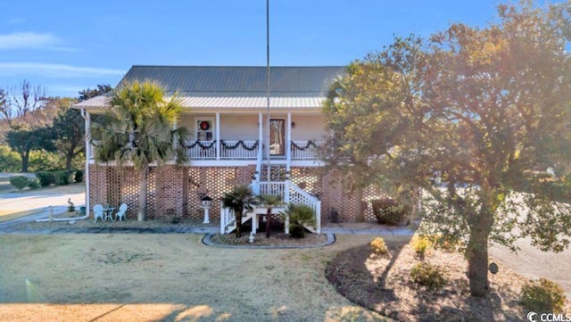 view of front of home with a porch and a front yard