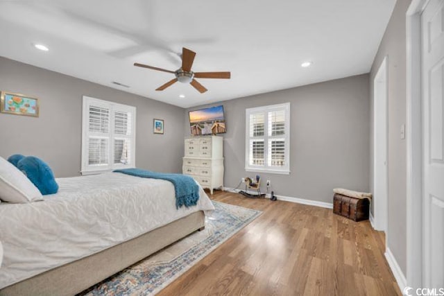 bedroom with ceiling fan and light hardwood / wood-style flooring