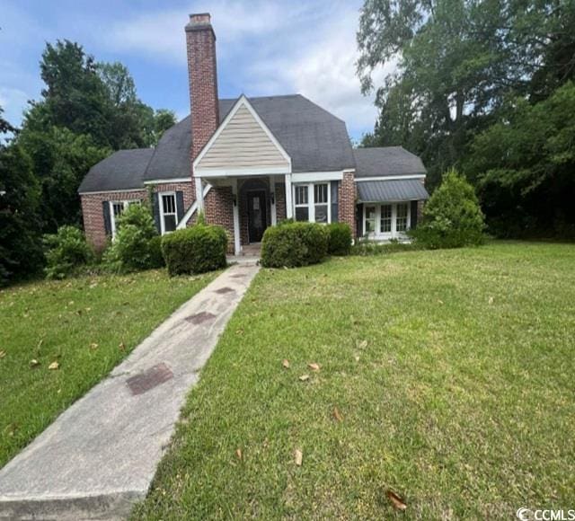 116 Singletary Ave, Lake City, SC 29560 - view of front of home with a front yard and a chimney