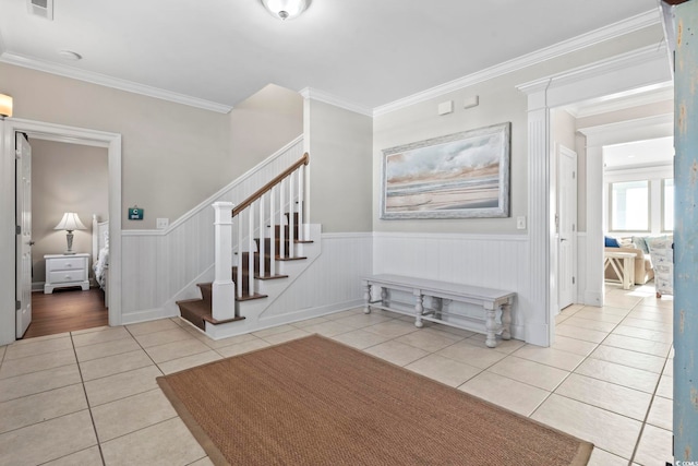 stairway featuring tile patterned flooring and ornamental molding