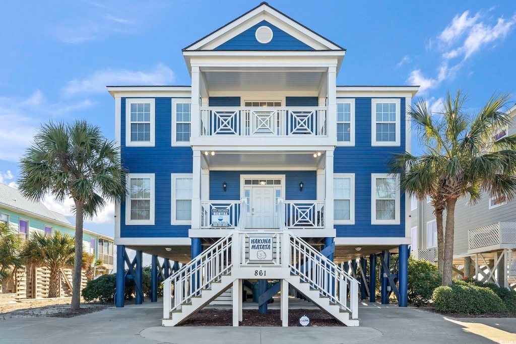 coastal inspired home with a carport and a balcony