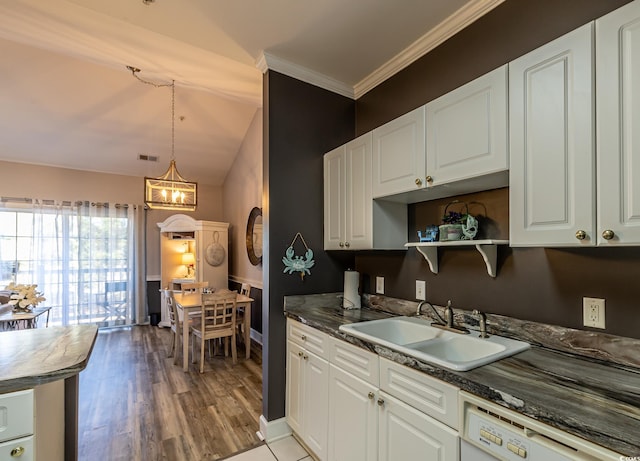 kitchen with visible vents, ornamental molding, white cabinets, white dishwasher, and a sink