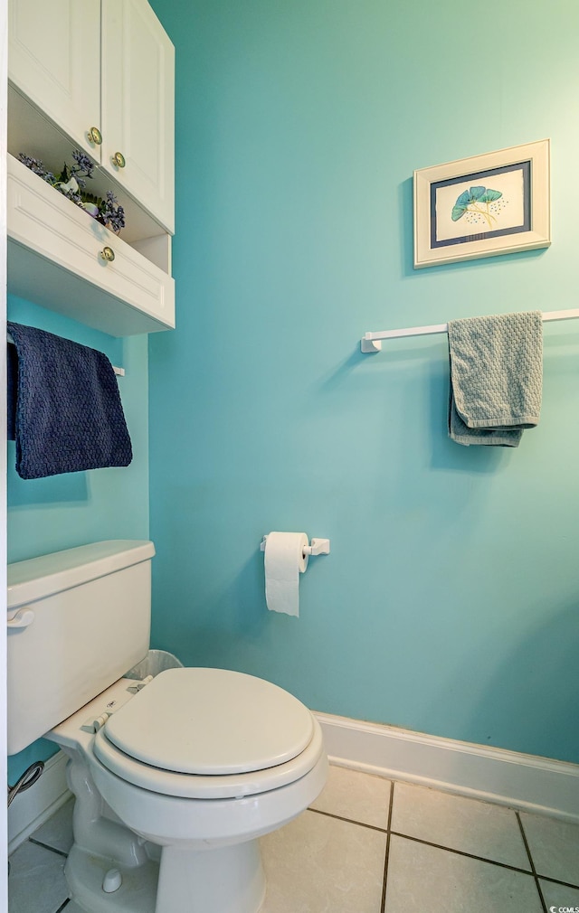 bathroom featuring baseboards, toilet, and tile patterned floors