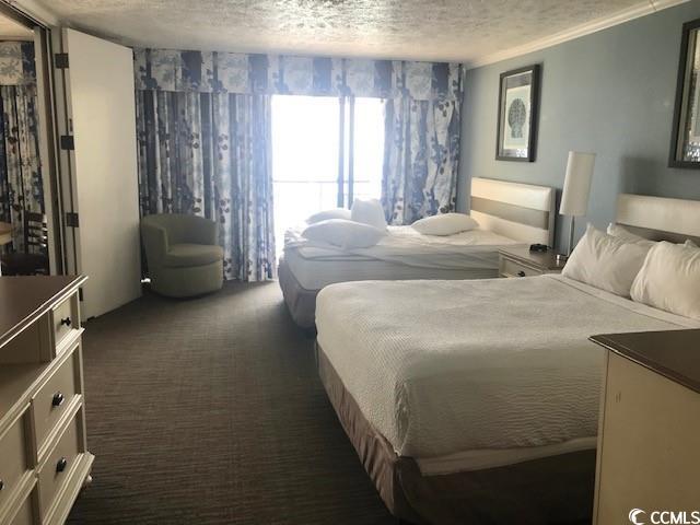 7100 N Ocean Blvd Unit 1608, Myrtle Beach, SC 29572 - bedroom with dark carpet and a textured ceiling