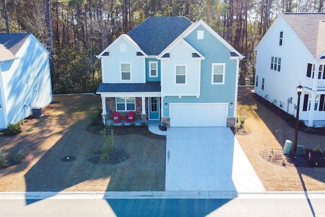 view of front of property with a garage, central AC unit, and covered porch