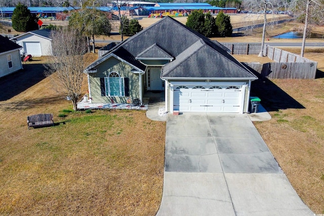 view of front of home with a garage and a front yard