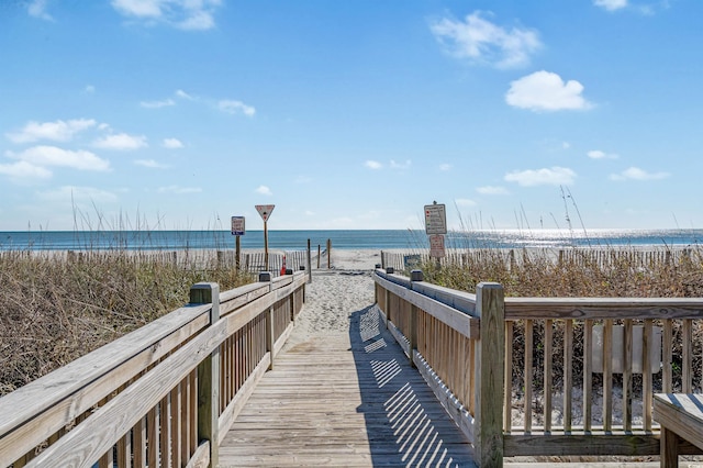 surrounding community featuring a view of the beach and a water view