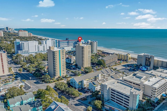 drone / aerial view featuring a beach view and a water view