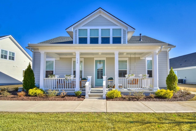 view of front of home featuring cooling unit and a front yard