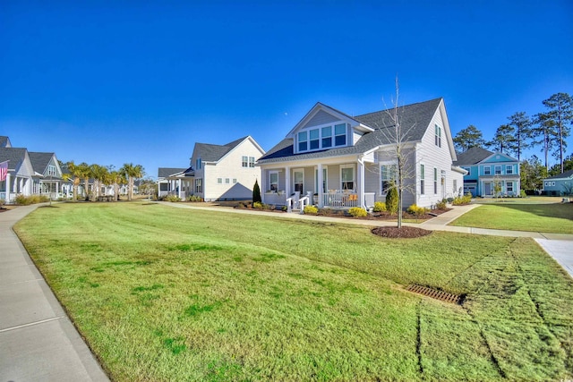 view of front facade with covered porch and a front yard