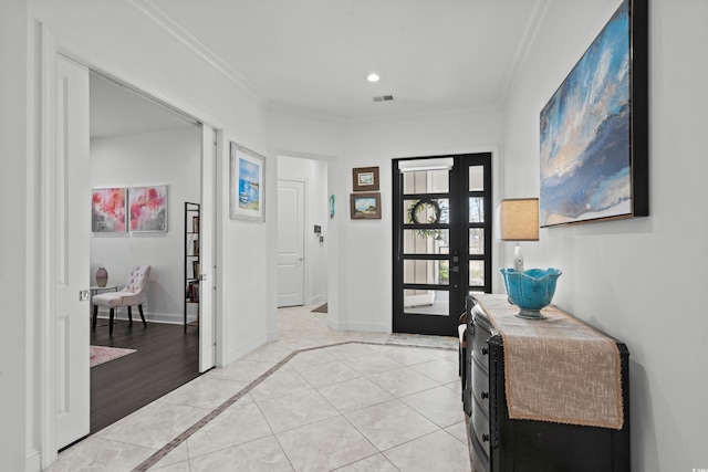 foyer with light tile patterned flooring and ornamental molding