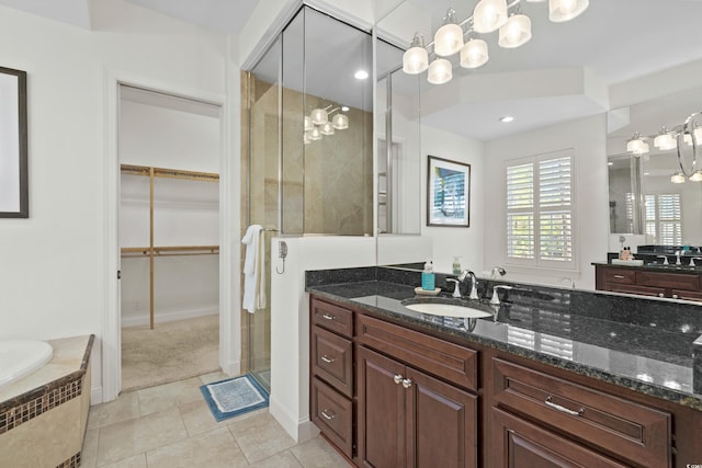 bathroom with tile patterned flooring, vanity, and independent shower and bath