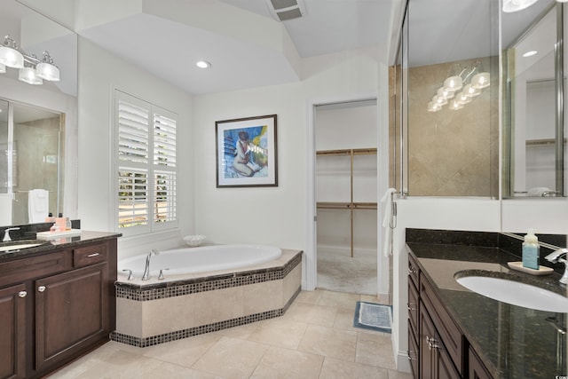 bathroom with tile patterned floors, vanity, and independent shower and bath