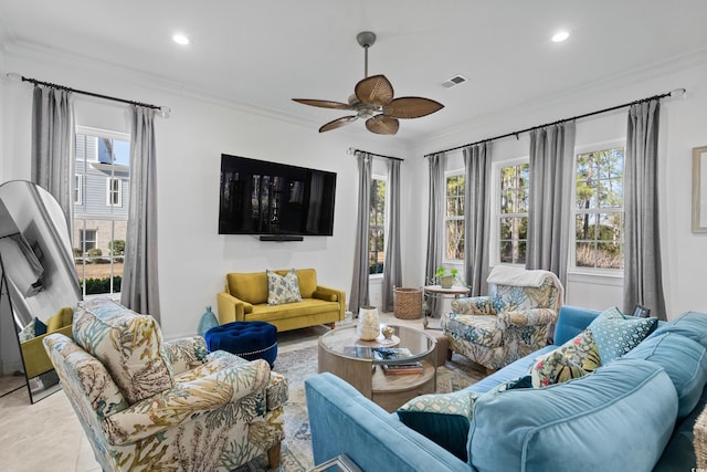 tiled living room with ceiling fan and crown molding