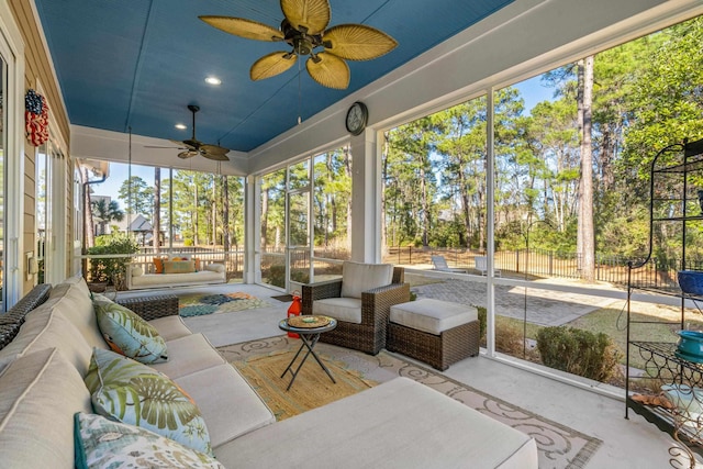 sunroom / solarium featuring ceiling fan