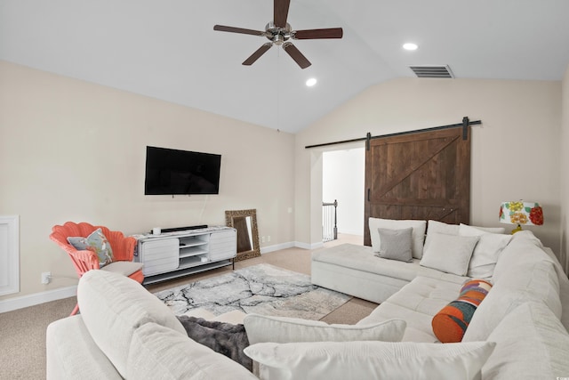 carpeted living room featuring ceiling fan, a barn door, and lofted ceiling