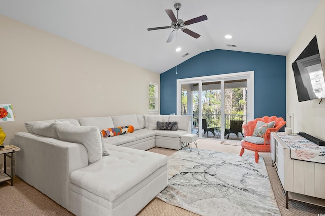 living room featuring ceiling fan, light carpet, and vaulted ceiling