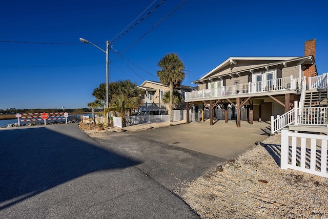 view of front of property with a porch and a carport