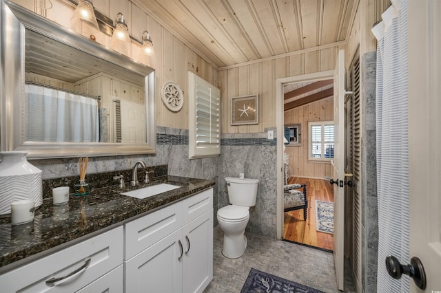 bathroom with vanity, wooden ceiling, vaulted ceiling, and toilet