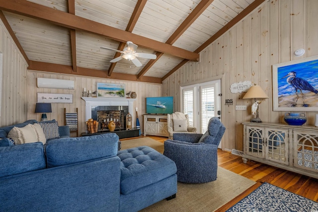 living room with ceiling fan, wooden walls, lofted ceiling with beams, an AC wall unit, and hardwood / wood-style floors