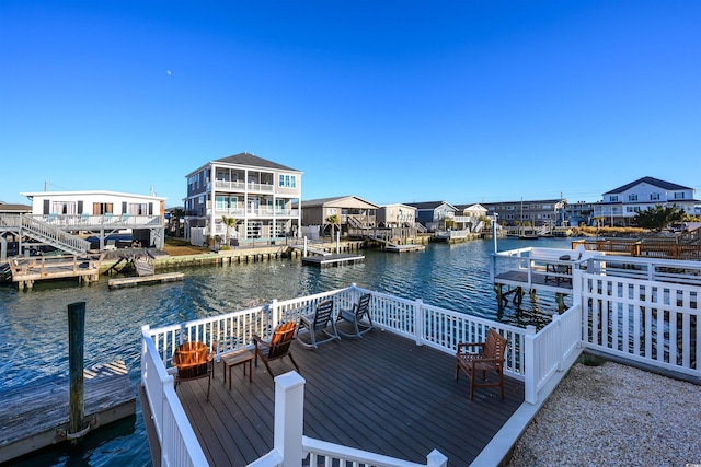 view of dock with a deck with water view