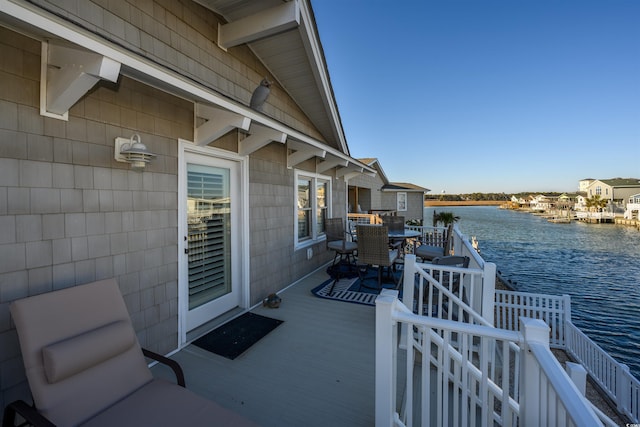 view of patio featuring a deck with water view