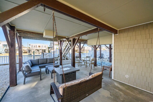 view of patio / terrace with an outdoor living space with a fire pit