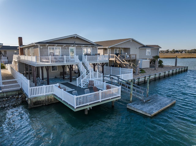 dock area with a deck with water view and a patio