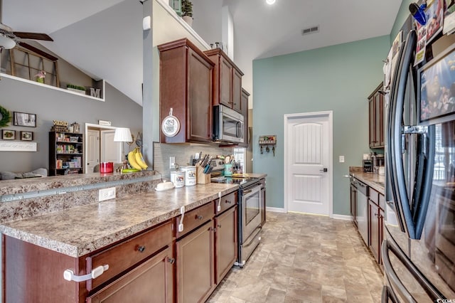 kitchen featuring backsplash, ceiling fan, high vaulted ceiling, and appliances with stainless steel finishes