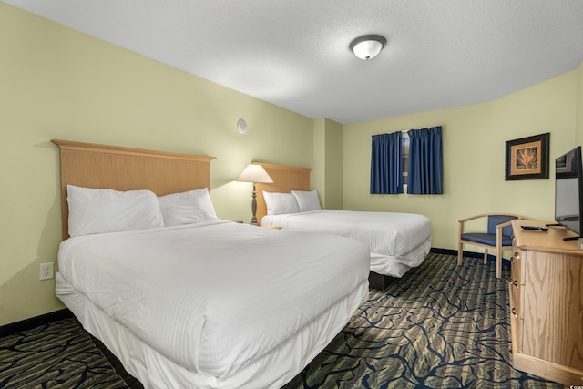 carpeted bedroom with a textured ceiling