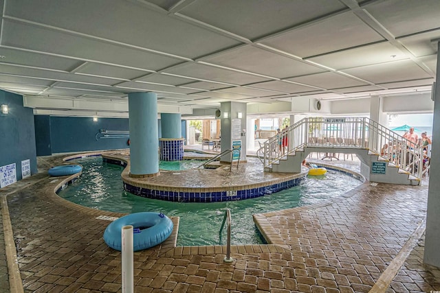 view of pool with an indoor hot tub