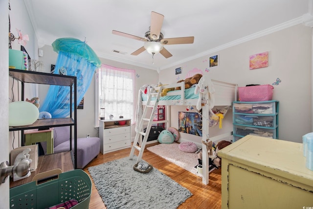 bedroom featuring ceiling fan, light hardwood / wood-style floors, and ornamental molding