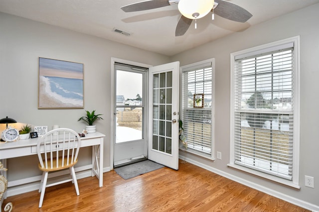 doorway to outside featuring ceiling fan and light wood-type flooring