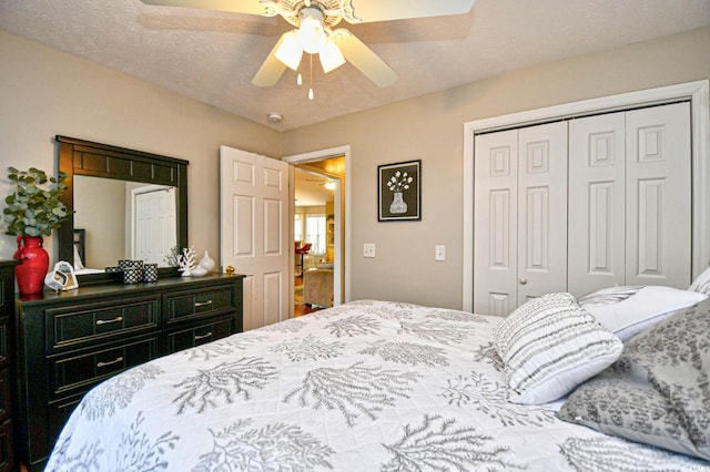 bedroom with ceiling fan, a closet, and a textured ceiling