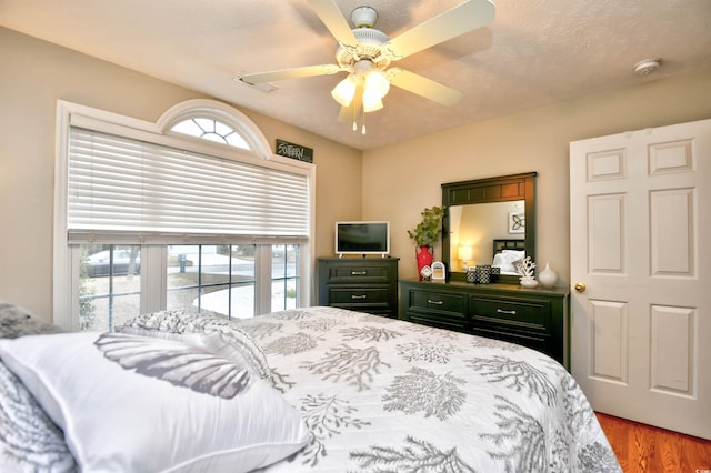 bedroom with wood-type flooring and ceiling fan