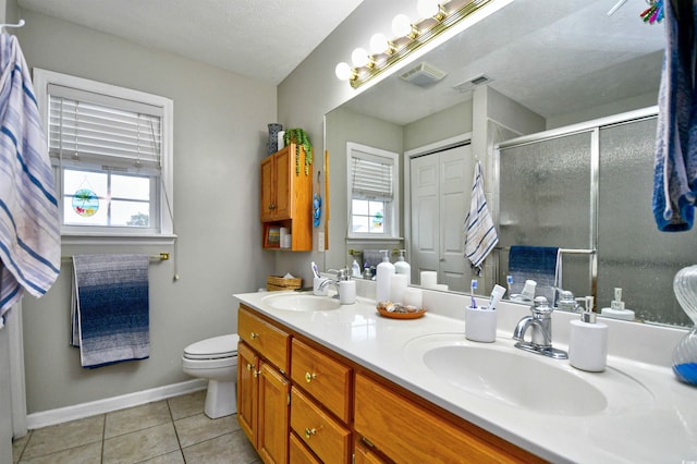 bathroom featuring plenty of natural light, tile patterned flooring, a textured ceiling, and vanity