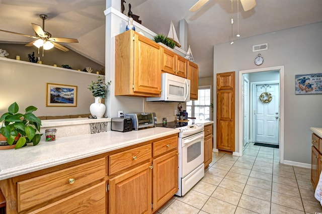 kitchen featuring ceiling fan, lofted ceiling, light tile patterned floors, and white appliances